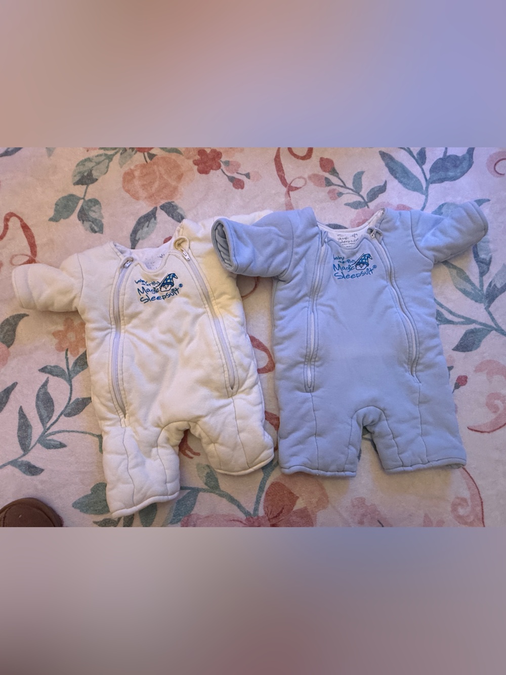 Two baby Merlin magic sleep suits- Cream and Light Blue